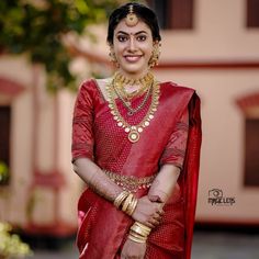 a woman in a red sari and gold jewelry