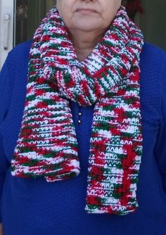 an older woman wearing a red, white and green knitted scarf on top of her head