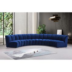 a large blue sectional sofa sitting on top of a white rug