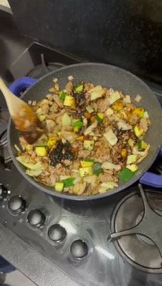 a pan filled with food sitting on top of a stove next to a frying pan