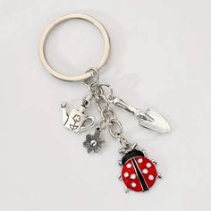 a ladybug keychain with two charms attached to it's sides