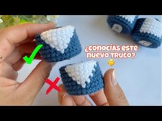 crocheted baby shoes with white and blue trims are shown in this video