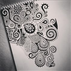 a spiral notebook with an intricate design on it