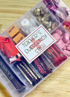 a plastic container filled with lots of different types of pens and pencils on top of a wooden table