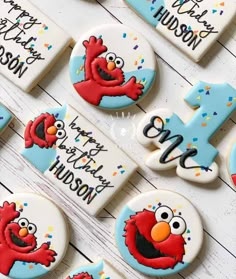 decorated cookies with the number one and sesame street characters are arranged on a white table