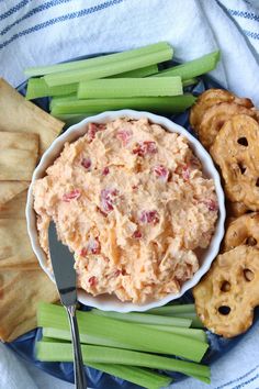 celery sticks, celery stalks and dip in a bowl on a plate