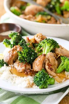 two plates with chicken and broccoli on them next to a bowl of rice