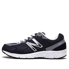 the new balance 997 running shoe is black and grey with white trimmings