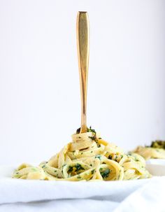 a wooden spoon is sticking out of a pasta dish