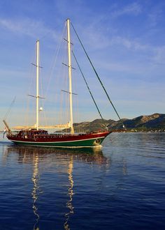 a sailboat floating on top of a body of water