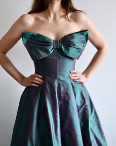 Vintage raw silk strapless ball gown with a huge bow on the front.  An amazing color, I've seen this referred to as diamond green purple, chameleon, or iridescent. Tulle underneath. Comes with a little matching scarf that you can use to cover your shoulders or perhaps tie in your hair.  No size marked. Approximately size 2/4. Measured flat, on the front: 49" long 15" bust 13.5" waist In very good vintage condition. Hook closure on the top has come undone, fully functioning without it as well. There are s couple of tiny white spots on the hem, see last photo. Ball Gown Green, Gown Green, Strapless Ball Gown, Come Undone, Press Tour, Purple Silk, Small Dress, Raw Silk, Dress Clothes For Women