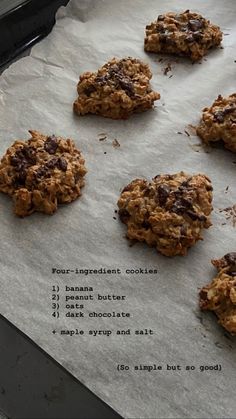 chocolate chip cookies sitting on top of parchment paper