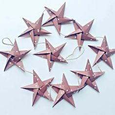 several pink paper stars are arranged in a circle