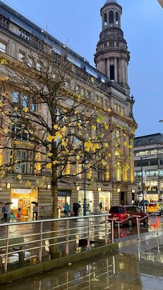 a building with a clock tower next to a tree