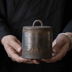 a person holding a pot in their hands