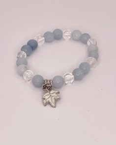 Aquamarine Blue and Round Selenite Clear round beads with White Leaf silver Charm - Single - 6 inch Elastic Bracelet This is a Beautiful Elastic style Bracelet. You can mix and match elastic Bracelets to make a unique look on your wrist.  This Bracelet wrap 6 inches around your wrist and is a great piece to add to your jewelry collection. beads are about 8mm. You will receive a nylon gift bag for your gift giving. You will choose gift bag color at checkout. If you have any questions send me a me Pretty Bracelet Colors, Round Bracelet, Winter Bracelet Ideas, Girly Bracelets, Diy Bracelet Designs, White Leaf, Beads Bracelet Design, Jewelry Accessories Ideas, Elastic Bracelet