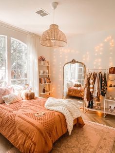 a bed room with a neatly made bed and lots of lights hanging from the ceiling