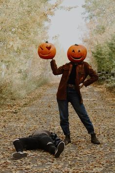 a person with two pumpkins on their heads