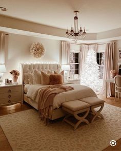 a bedroom with a bed, dresser and chandelier