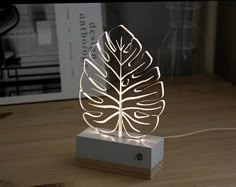 a light up leaf on top of a wooden table