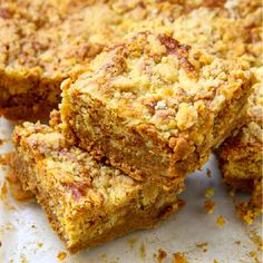 three pieces of cake sitting on top of a piece of parchment paper with crumbs all over it