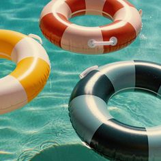 three inflatable floats floating on the water