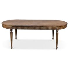 an oval wooden table with ornate carvings on the top and legs, against a white background