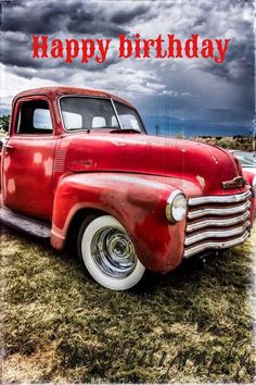 an old red truck is sitting in the grass with a happy birthday message on it