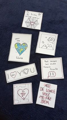 five cards with drawings on them are arranged in the shape of heart and spider webs