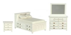 a white bedroom set with dresser, mirror and bed