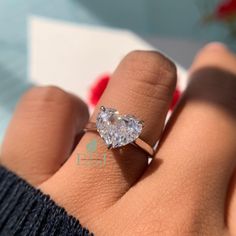 a woman's hand with a diamond ring on it