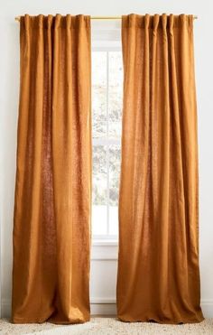 an orange curtain hanging in front of a window