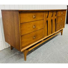 This listing is for a Mid-Century Modern Broyhill Brasilia Walnut 9-Drawer Dresser. Featuring a straight line design, three drawers on each side with original Brasilia brass hardware, sculpted center doors that open up to three hidden drawers, modern legs, and a beautiful walnut finish. This is an exceptional combination of quality and design by Broyhill! Straight Line Design, Broyhill Brasilia, Straight Line Designs, Mid Century Dresser, Hickory Chair, 9 Drawer Dresser, Hooker Furniture, Straight Line, Dressers And Chests