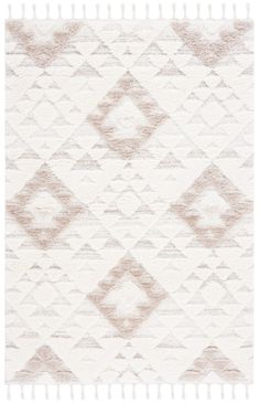 a white rug with diamonds and fringes on it