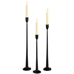 two black candles stand next to each other