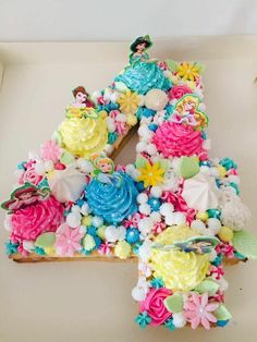 there is a letter made out of cupcakes and flowers