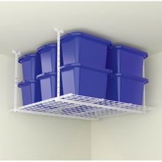 three blue plastic containers are hanging from the ceiling