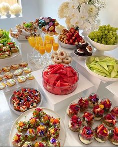 a table filled with lots of different types of food on plates and bowls next to each other