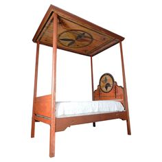 a bed with a wooden canopy over it