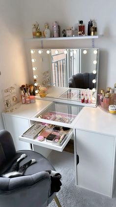 a vanity with lights on and a chair in front of the mirror that is open