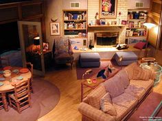 a living room filled with furniture and a fire place