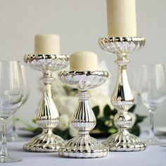 there are many silver candles on the table