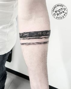 a man's arm with a black and white photo on it that says,