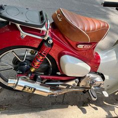 a red and white motorcycle parked on the street