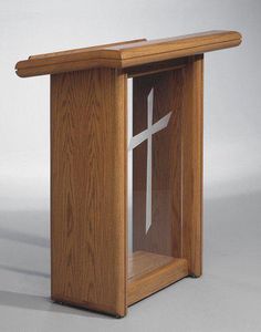 a wooden pulpit with a white cross on the front and side panel, in oak