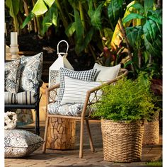 an outdoor patio with chairs, pillows and potted plants