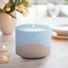 a blue candle sitting on top of a table