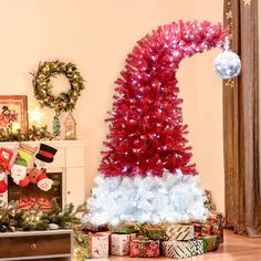 a red and white christmas tree surrounded by presents