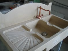 the sink is made out of wood and has two faucets on it's sides