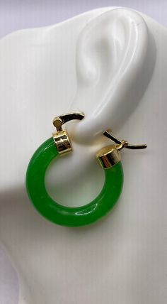 "These are lovely Green Jade Hoop Earrings  Approximately 1 inch See our full collection of Vintage Jade: https://www.etsy.com/shop/EastVillageBangles?section_id=38654118 Jade, a birthstone of August, is often the gemstone associated with the twelfth wedding anniversary.  Jade comes in Nephrite and Jadeite varieties, each a crystallized form of silica. Jade draws its name from the Latin ilia, meaning 'flanks, kidney area' giving rise to the informal \"loinstone\".  Jade is known as a symbol of good luck, longevity, and wisdom promoting self acceptance and love. Jade brings a restoring energy balancing Heart chakra.   Jade is a relatively hard stone rating 6.5 on the Mohs scale.  Jade can be cleaned with mild soap in warm water, and a soft toothbrush or cloth.  Avoid harsh cleansers, bleach Cheap Handmade Jade Earrings, Affordable Jade Bead Earrings, Modern Hinged Earrings As Gifts, Modern Hinged Earrings For Gift, Hypoallergenic Green Huggie Earrings, Elegant Green Hoop Huggie Earrings, Elegant Green Small Hoop Huggie Earrings, Green Hoop Huggie Earring, Elegant Green Huggie Earrings